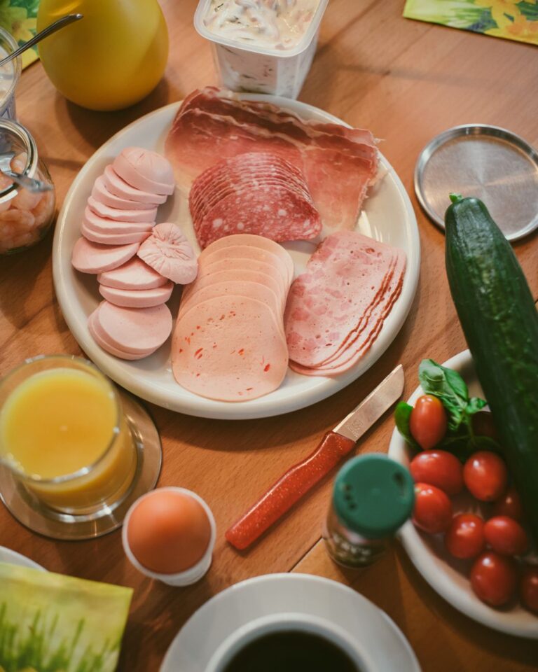 assorted breakfast meats and fresh vegetables